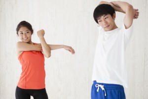 Young men and women have a stretch movement of the arm